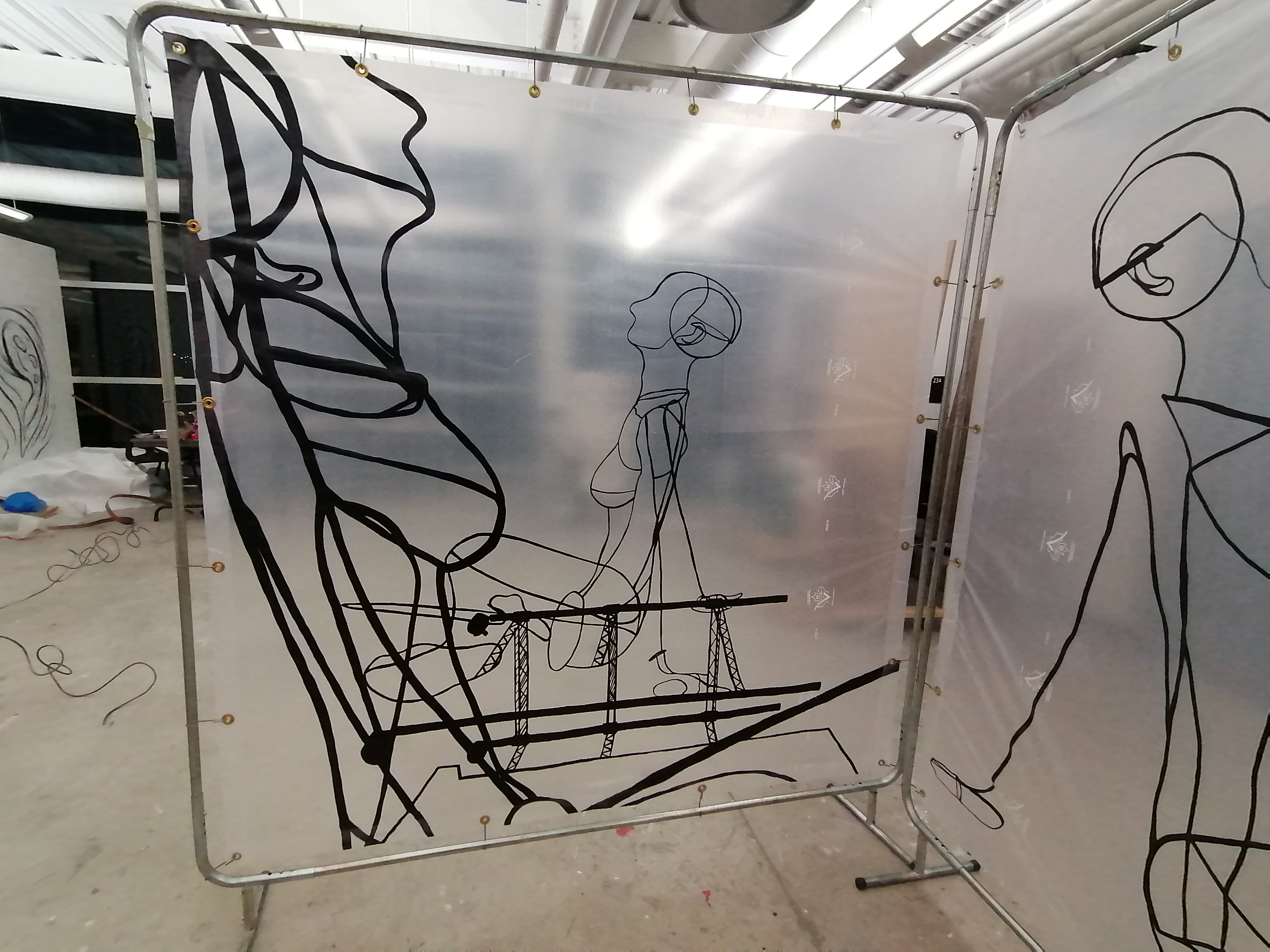 an artwork by Ada Denil consisting of translucent welding screens with line drawings