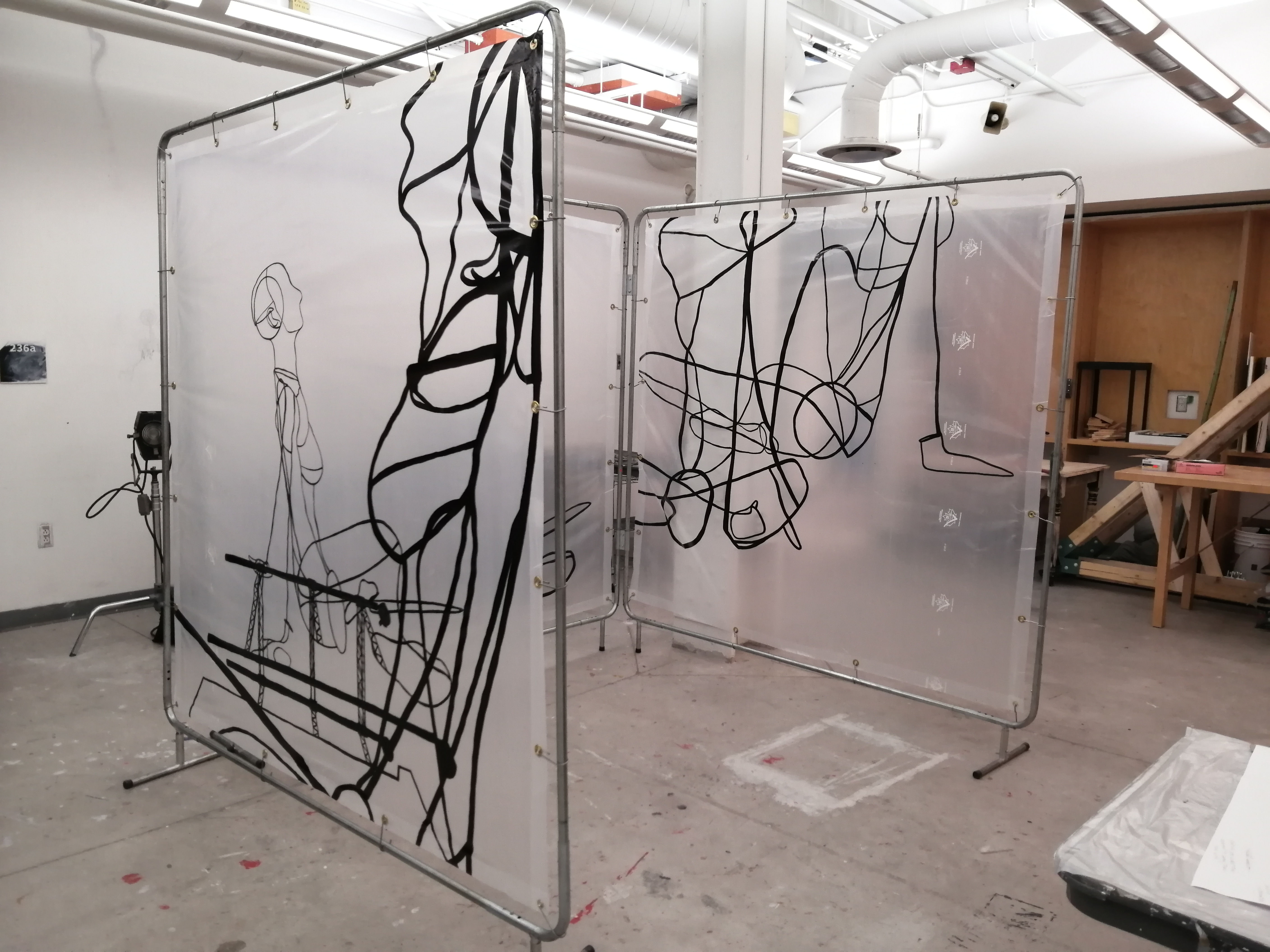 an artwork by Ada Denil consisting of translucent welding screens with line drawings