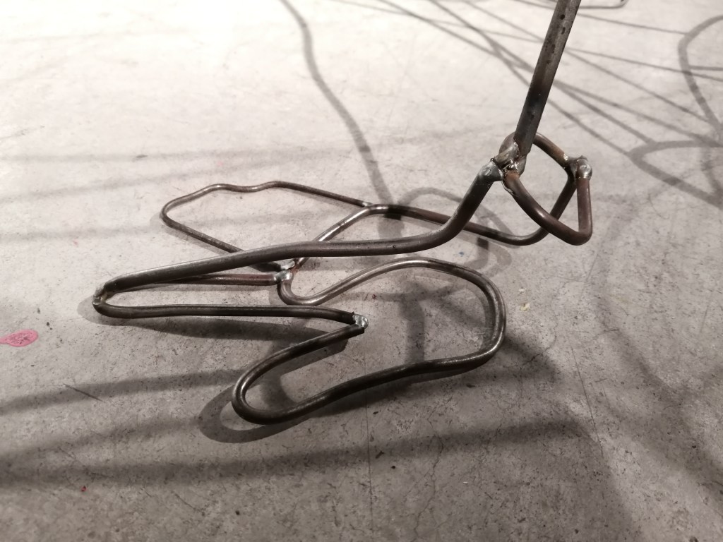 a steel figure constructed with steel rods created by Ada Denil