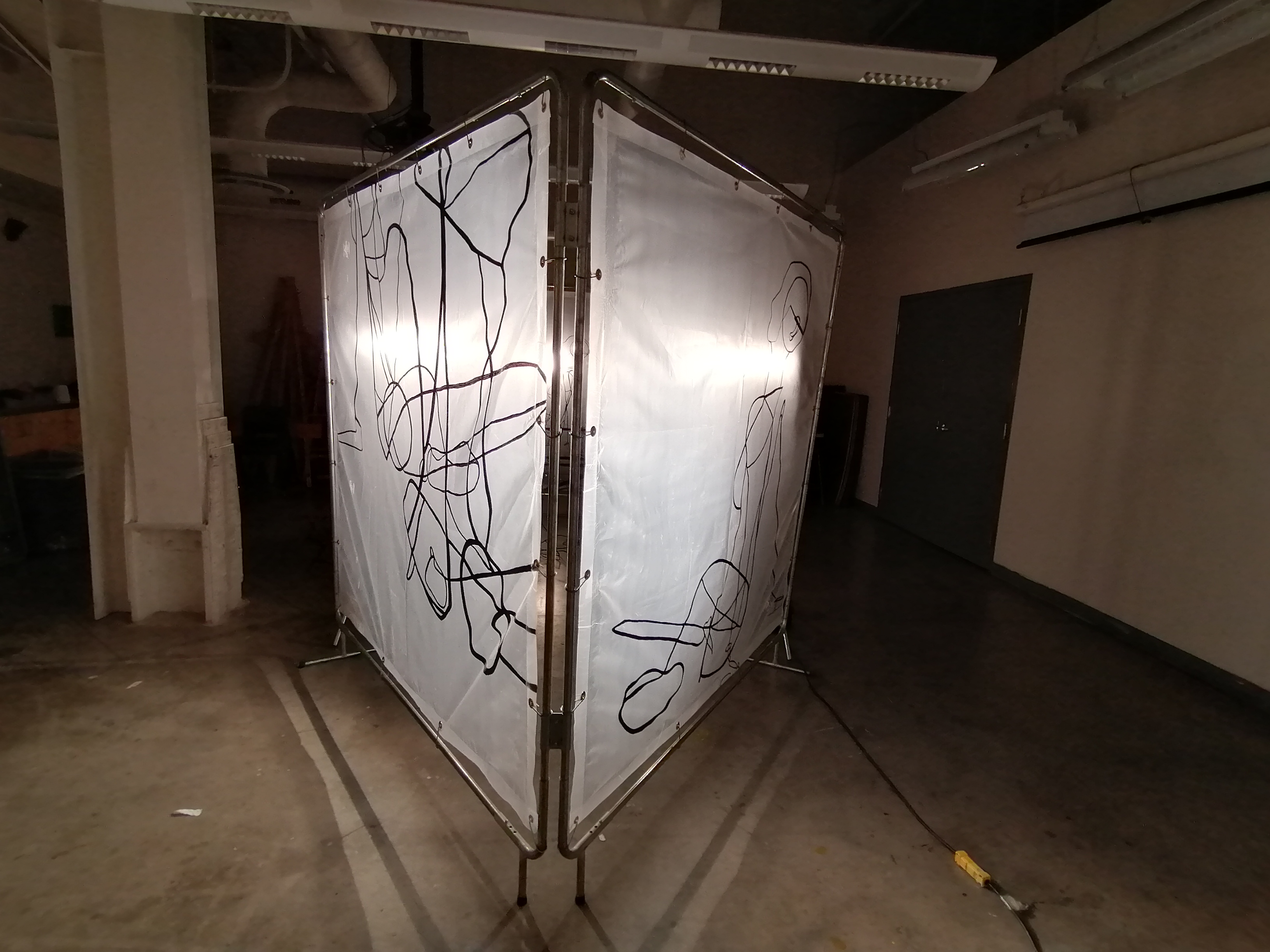 an artwork by Ada Denil consisting of translucent welding screens with line drawings