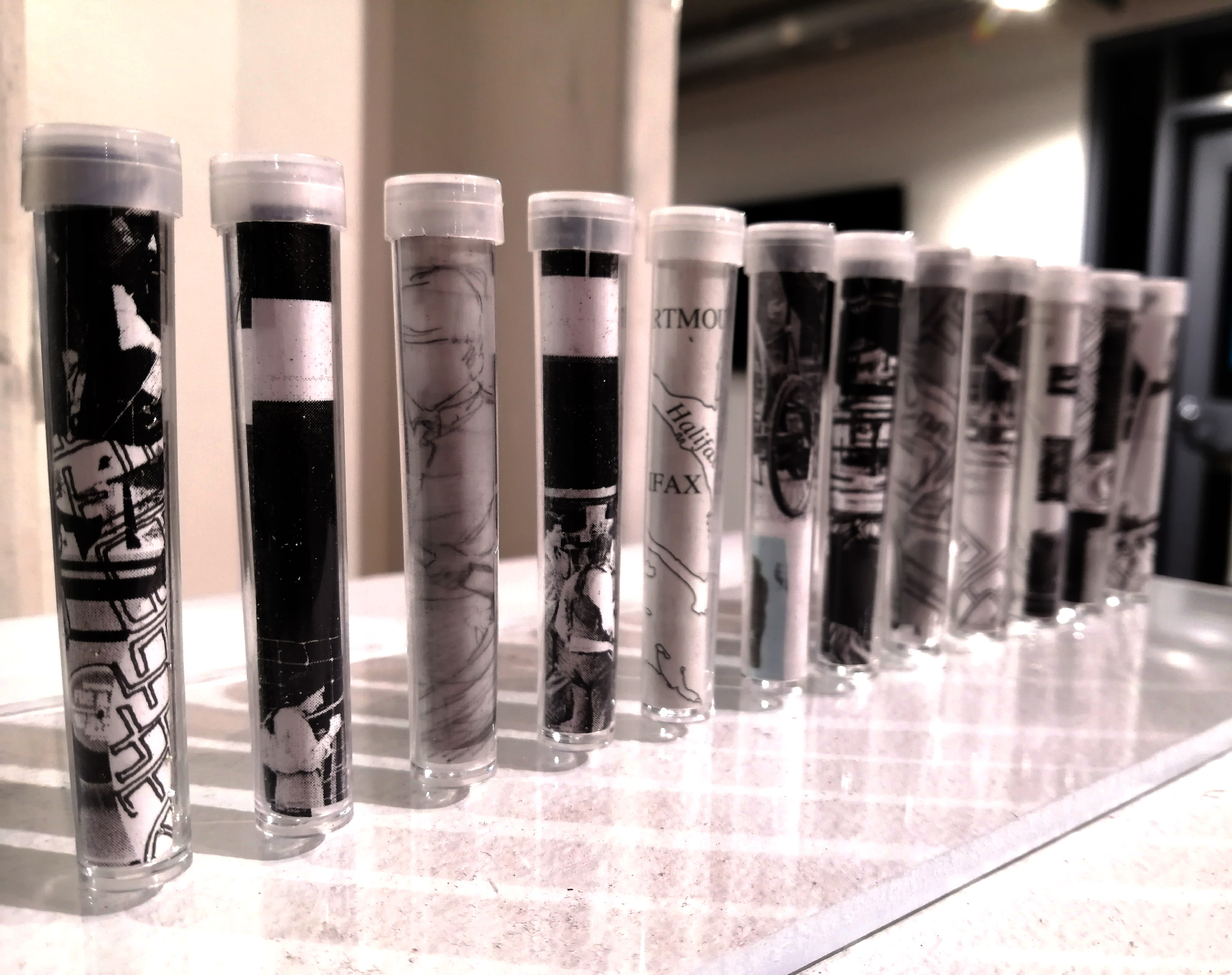 a series of small bottles with images of the city inside