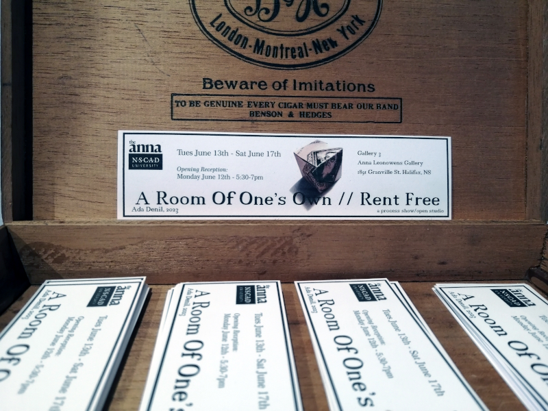 a display of bookmarks advertising the a show by Ada Denil titled A Room of One's Own // Rent Free at the Anna Leonowens Gallery in Halifax, NS