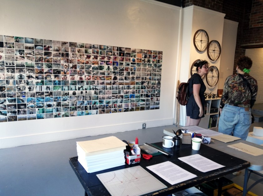 people engaging with the art exhibit titled "A Room of One's Own // Rent Free" by Ada Denil